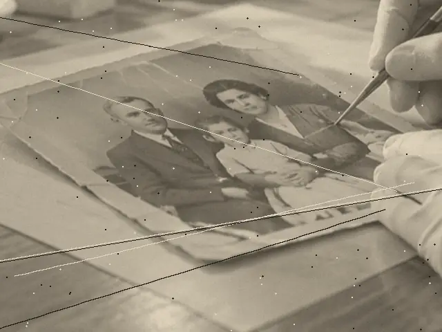A black and white family portrait, washed out and scratched